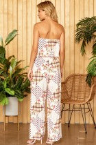 This patchwork print jumpsuit features tube like bodice with boxy pants. Elastic on the waist. Lined, woven.
100% RAYON