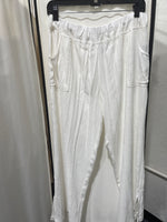 White modal, rayon, and spandex blend, wide leg pants, super comfortable, elastic waist band, front pockets, side slits bottom of legs. Oversized can size down