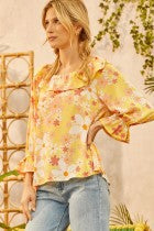 Cute daisy floral print all over this cute top with ruffle on the neckline featuring 3/4" sleeves. Relaxed fit. Easy body. Woven.